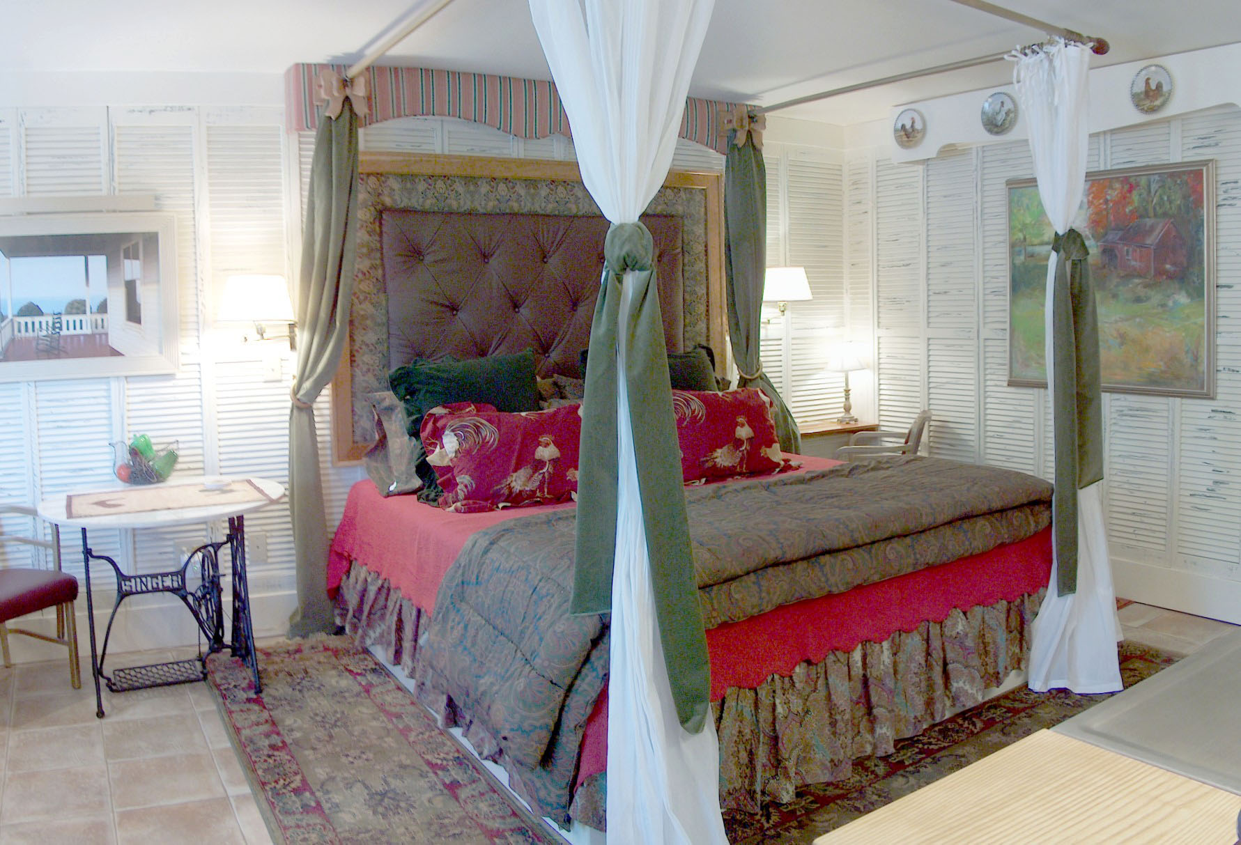 A four poster bed dressed in floral linens in a guest room at Old Spring Farm